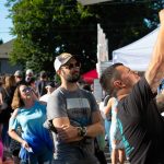 People wait in line for some bites during Taste Edmonds on Saturday, August 12, 2023, at Francis Anderson Play Field in Edmonds, Washington. (Ryan Berry / The Herald)