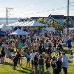 Hundreds hang out near the stage during Taste Edmonds on Saturday, August 12, 2023, at Frances Anderson Play Field in Edmonds, Washington. (Ryan Berry / The Herald)