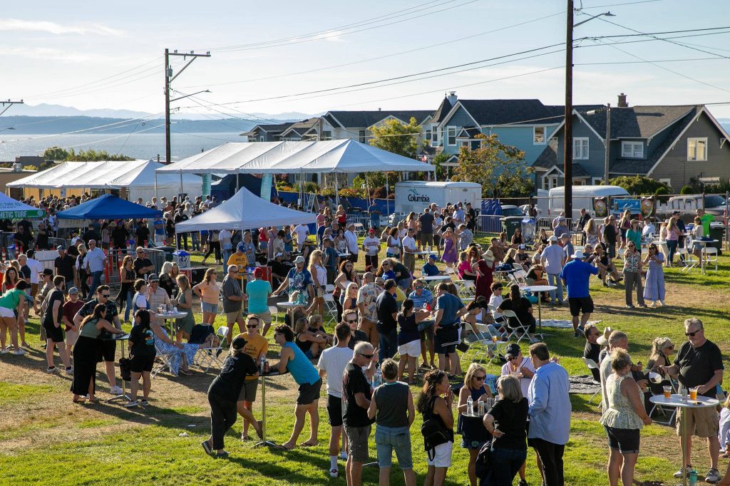 Hundreds hang out near the stage during Taste Edmonds on Saturday, August 12, 2023, at Frances Anderson Play Field in Edmonds, Washington. (Ryan Berry / The Herald)