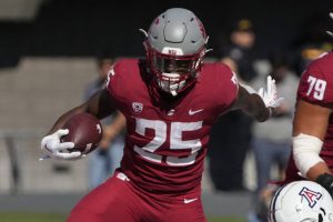 FILE - Washington State running back Nakia Watson (25) breaks away from Arizona safety Jaxen Turner in the first half during an NCAA college football game, Saturday, Nov. 19, 2022, in Tucson, Ariz. Washington State opens their season at Colorado State on Sept. 2. (AP Photo/Rick Scuteri, File)