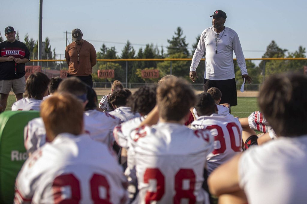 Head Coach Archie Malloy talks to the team during a football practice Thursday at Mountlake Terrace High School. (Annie Barker / The Herald)