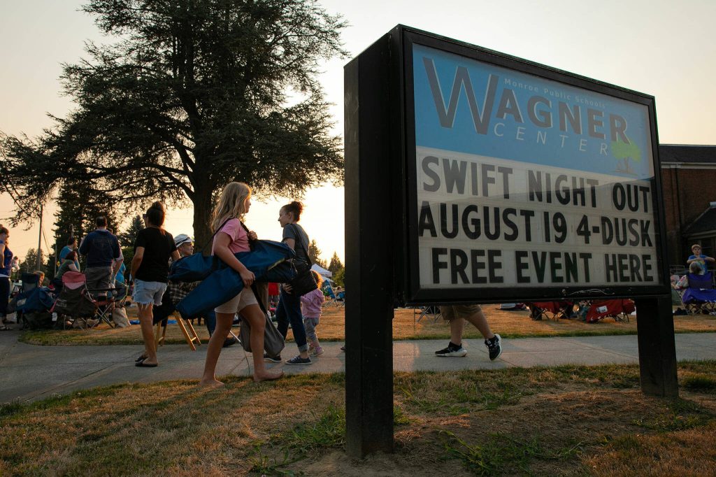 A crowd of over 100 people find their seats in the lawn during the Pilchuck Audubon Societys Swift Night Out on Saturday, August 19, 2023, at Frank Wagner Elementary School in Monroe, Washington. (Ryan Berry / The Herald)