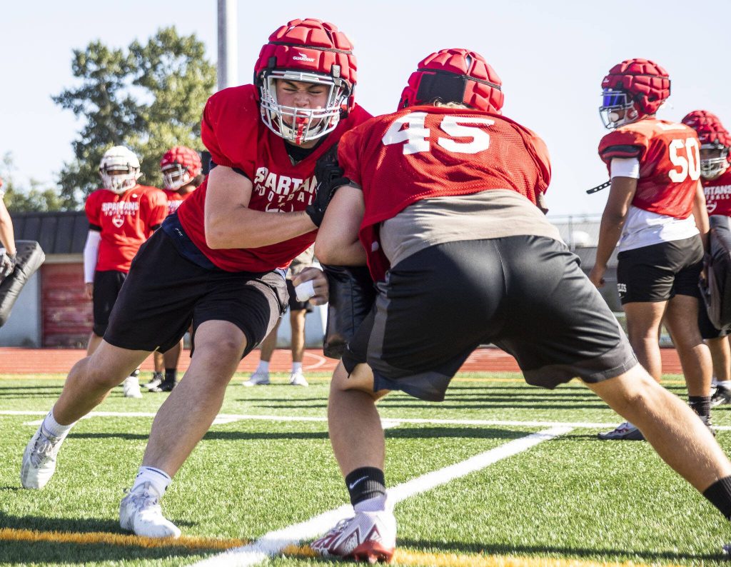 Stanwoods offensive line runs through hitting drills at practice on Friday, Aug. 18, 2023 in Stanwood, Washington. (Olivia Vanni / The Herald)