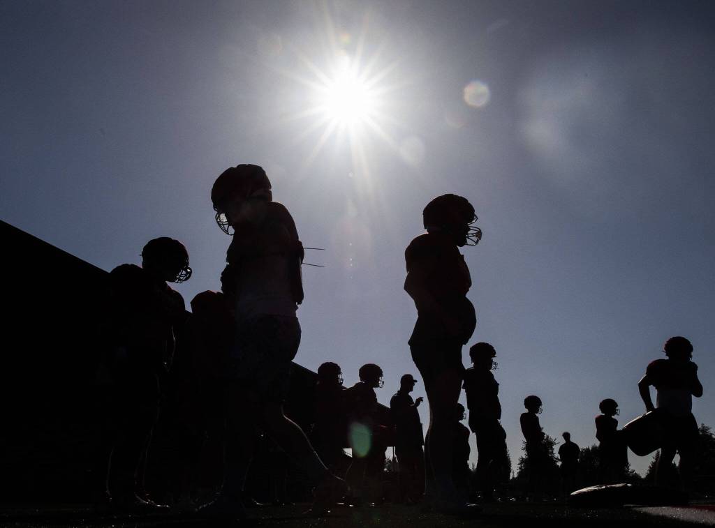 Stanwood football players run through drills at practice on Friday, Aug. 18, 2023 in Stanwood, Washington. (Olivia Vanni / The Herald)