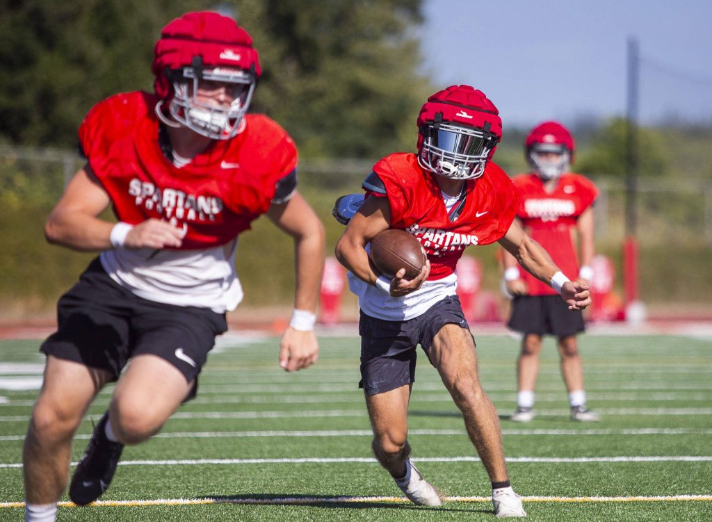 runs the ball during practice on Friday, Aug. 18, 2023 in Stanwood, Washington. (Olivia Vanni / The Herald)