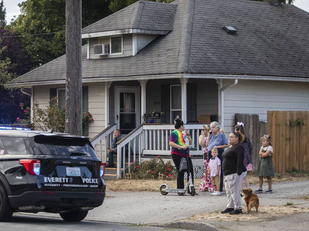 Neighbors gather along 23rd Street next to the scene of shooting on Tuesday, Aug. 22, 2023 in Everett, Washington. (Olivia Vanni / The Herald)
