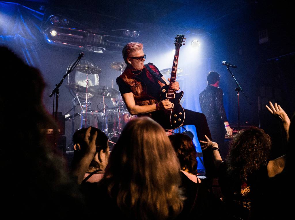 Dave Dodge stands on a speaker while playing his guitar during Nite Waves show at Tony Vs Garage on Saturday, June 8, 2019 in Everett, Wash. (Olivia Vanni / The Herald)