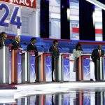 Republican presidential candidates (from left) former Arkansas Gov. Asa Hutchinson, former New Jersey Gov. Chris Christie, former Vice President Mike Pence, Florida Gov. Ron DeSantis, businessman Vivek Ramaswamy, former U.N. Ambassador Nikki Haley, Sen. Tim Scott, R-S.C., and North Dakota Gov. Doug Burgum stand on stage and listen to a prayer before the Republican presidential primary debate hosted by FOX News, Wednesday in Milwaukee. (Morry Gash / Associated Press)