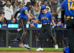 The Mariners J.P. Crawford (left) greets Dominic Canzone after they scored on a two-run single by Eugenio Suárez during the fourth inning of a game against the Royals on Friday in Seattle. (AP Photo/Lindsey Wasson)
