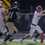 Stanwood’s Canyon Bumgarner reaches the ball in to the end zone looking for a touchdown during the Stilly Cup against Arlington on Friday, Sept. 30, 2022 in Arlington, Washington. (Olivia Vanni / The Herald)