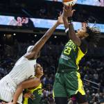 Seattle Storms Mercedes Russell holds back Chicago Skys Elizabeth Williams while Seattle Storms Jordan Horston jumps up to make a rebound during the game at Climate Pledge Arena on Sunday, Aug. 27, 2023 in Seattle, Washington. (Olivia Vanni / The Herald)