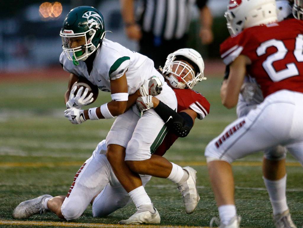 Edmonds-Woodways Jesse Hart tries to fight through a tackle during a game against Snohomish on Sept. 23, 2022, at Snohomish High School. (Ryan Berry / The Herald)