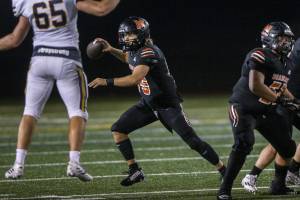 Monroe’s Blake Springer scrambles to look for an open teammate to pass to during the game against Ferndale on Friday, Oct. 28, 2022 in Monroe, Washington. (Olivia Vanni / The Herald)