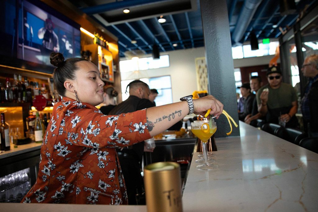 The bar kicks into gear as visitors eat and drink during the opening of Fisherman Jacks at the Port of Everett on Wednesday, August 30, 2023, in Everett, Washington. (Ryan Berry / The Herald)