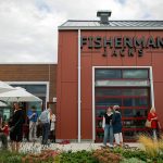 A crowd begins to form before a large reception for the opening of Fisherman Jack’s at the Port of Everett on Wednesday, August 30, 2023, in Everett, Washington. (Ryan Berry / The Herald)