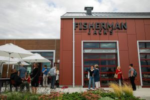 A crowd begins to form before a large reception for the opening of Fisherman Jack’s at the Port of Everett on Wednesday, August 30, 2023, in Everett, Washington. (Ryan Berry / The Herald)