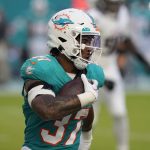 Running back Myles Gaskin carries the ball during a preseason game between the Dolphins and Falcons on Aug. 11 in Miami Gardens, Fla. (AP Photo/Marta Lavandier)