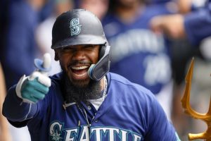 Seattle Mariners' Teoscar Hernandez gives a thumbs up as he celebrates in the dugout after hitting a three-run home run against the Oakland Athletics during the third inning of a baseball game, Wednesday, Aug. 30, 2023, in Seattle. (AP Photo/Lindsey Wasson)