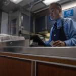 Amtrak worker Darryl Sumida rings up a transaction in the cafe car. (Annie Barker / The Herald)