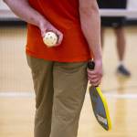 Darren Stahl holds a pickleball while listening to the rules of the game during a beginners pickleball clinic in Edmonds. (Olivia Vanni / The Herald)