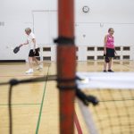 Mary Davis, left, serves the ball while Mary Jane Goss, right, waits for a return during practice matches on Monday, July 31, 2023 in Edmonds, Washington. (Olivia Vanni / The Herald)