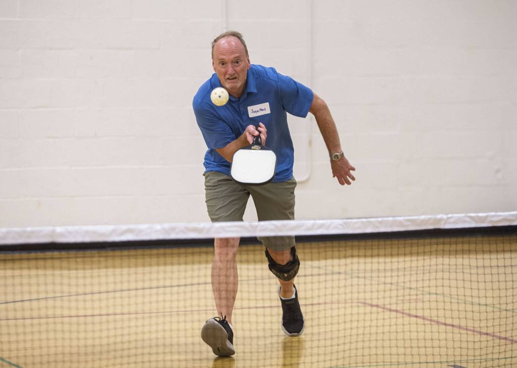 Scott Hyde hustles to return a serve in Edmonds. (Olivia Vanni / The Herald)
