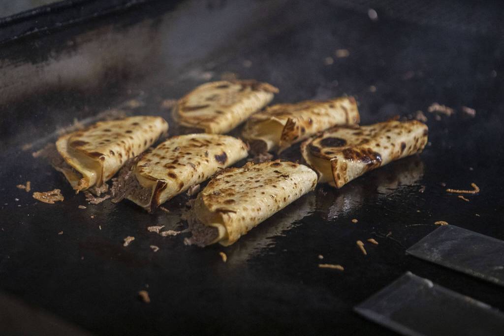 Beef birria tacos cook on a stove at El Mariachi in Everett, Washington on Wednesday, July 5, 2023. (Annie Barker / The Herald)