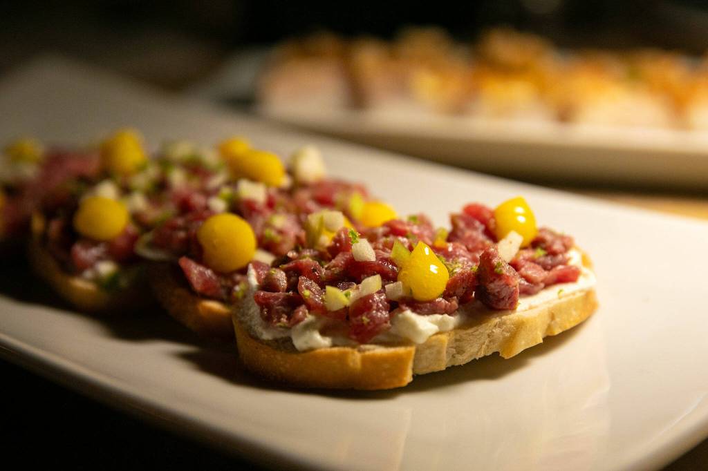 Steak tartare is served over ricotta cheese on sourdough at 16Eleven on Wednesday, August 23, 2023, in downtown Everett, Washington. (Ryan Berry / The Herald)