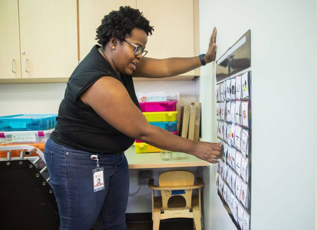 Irene Jeffries shows how her students will use a communication board for exercises and other tasks in the classroom on Wednesday, Aug. 30, 2023 in Everett, Washington. (Olivia Vanni / The Herald)