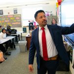 Jonnathan Yepez Carino writes out an example of how credit card use impacts credit score during Auliilani De La Cruz’s class at Mariner High on Wednesday, May 31, 2023, in Everett, Washington. (Ryan Berry / The Herald)