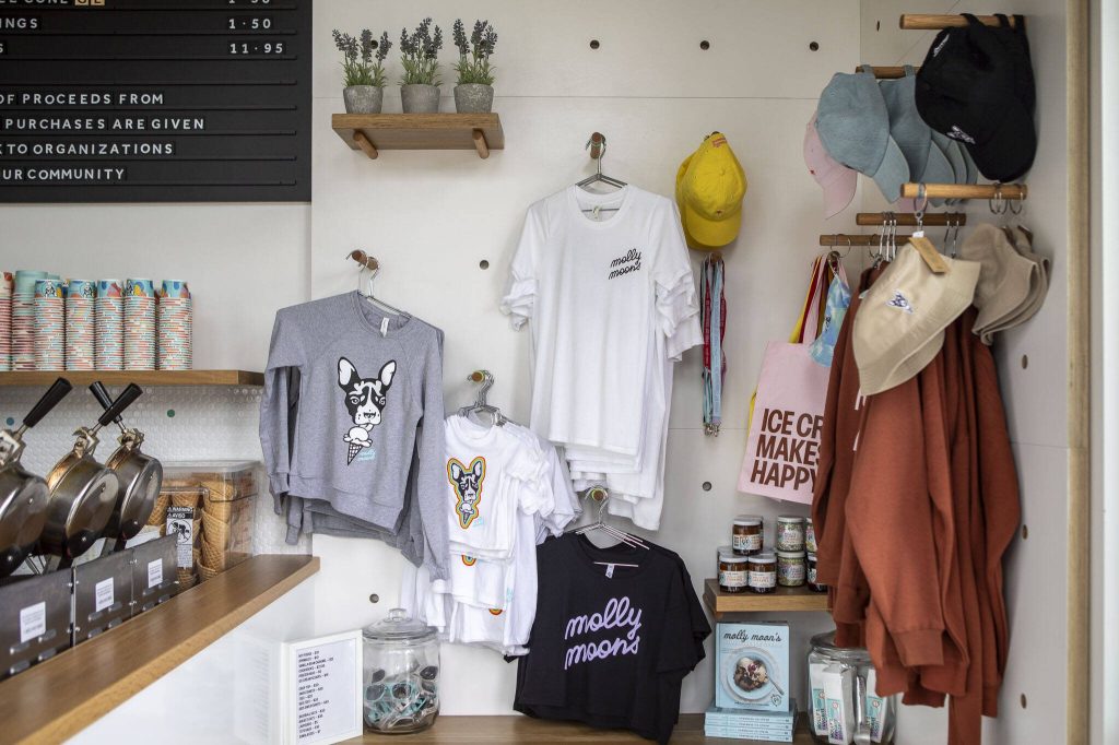 Merchandise including shirts and hats for sale at Molly Moons Ice Cream in Edmonds, Washington on Wednesday, Aug. 30, 2023. (Annie Barker / The Herald)