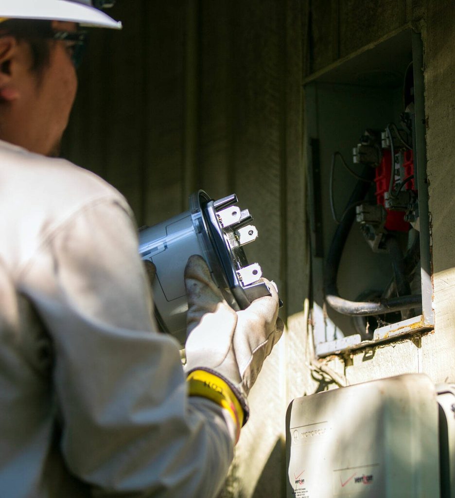 PUD Meter Journeyman Evan Aratani installs a new smart reader at a single family home Thursday, Sept. 21, 2023, in Mill Creek, Washington. (Ryan Berry / The Herald)