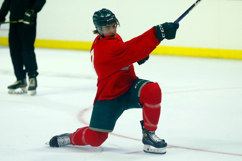 Dexter Whittle goes down to a knee on a slap shot during the first day of Silvertips training camp on Thursday, August 31, 2023, at Angel of the Winds Arena in Everett, Washington. (Ryan Berry / The Herald)