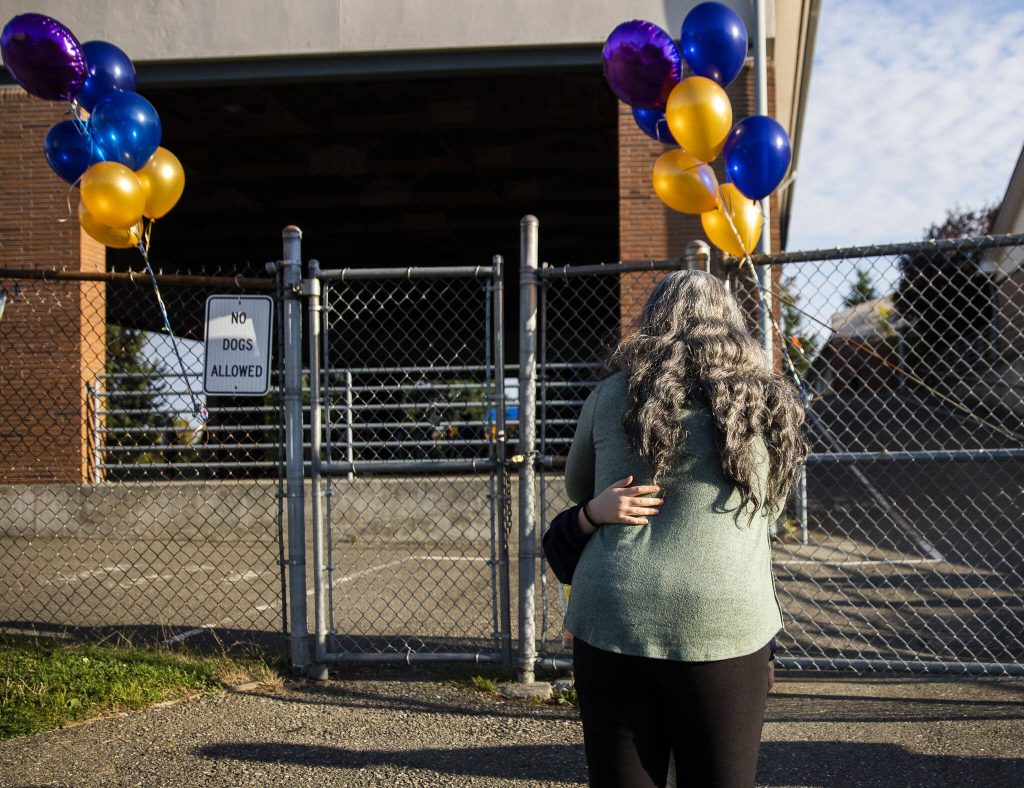 A child hugs their parent before leaving to start their first day of school at Whittier Elementary on Wednesday, Sept. 6, 2023 in Everett, Washington. (Olivia Vanni / The Herald)
