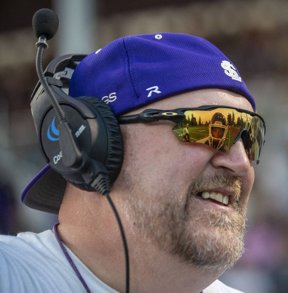 Lake Stevens defensive coordinator Eric Dinwiddie talks to a player during a football game between Lake Stevens and Garfield at Lake Stevens High School in Lake Stevens, Washington on Friday, Sept. 1, 2023. The Vikings won 48-21. (Annie Barker / The Herald)