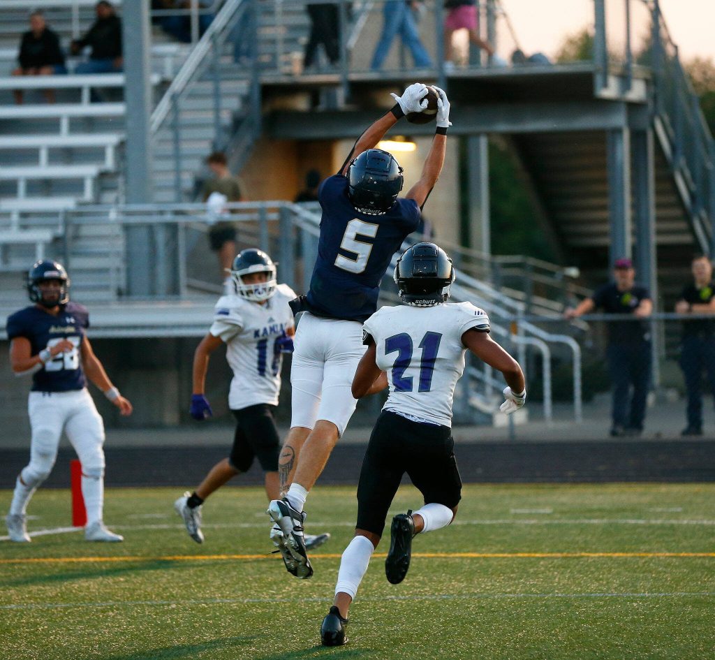 Arlington senior wideout Jacoby Falor comes down with a touchdown catch during the season opener against Kamiak on Friday, Sep. 1, 2023, at Arlington High School in Arlington, Washington. (Ryan Berry / The Herald)