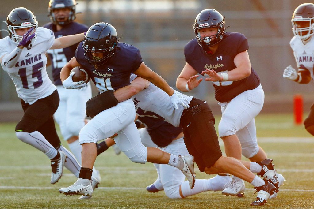Arlington senior Stevie Balderas runs forward for extra yards after the catch during the season opener against Kamiak on Friday, Sep. 1, 2023, at Arlington High School in Arlington, Washington. (Ryan Berry / The Herald)
