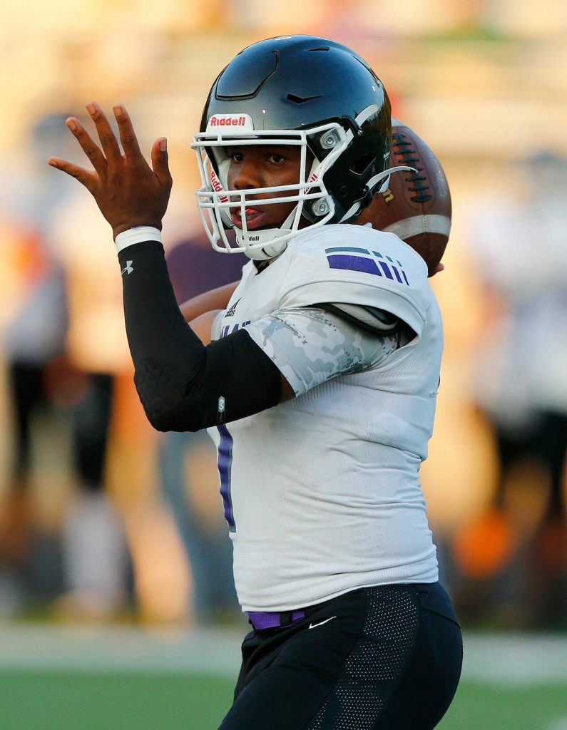 Kamiak quarterback Jericho Ishmael turns to throw a short bubble screen during the season opener against Arlington on Friday, Sep. 1, 2023, at Arlington High School in Arlington, Washington. (Ryan Berry / The Herald)