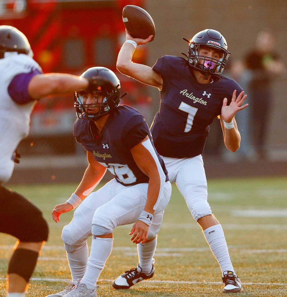 Arlington junior quarterback Leyton Martin throws a short pass during the second quarter of the season opener against Kamiak on Friday, Sep. 1, 2023, at Arlington High School in Arlington, Washington. (Ryan Berry / The Herald)