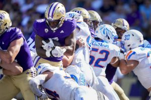 Washington running back Dillon Johnson carries for a touchdown against Boise State during the second half of an NCAA college football game Saturday, Sept. 2, 2023, in Seattle. (AP Photo/Lindsey Wasson)