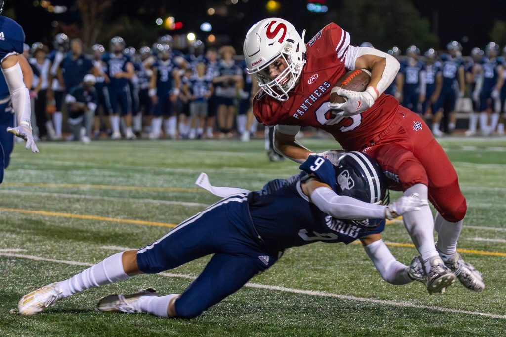 Glacier Peaks Isaiah Cuellar (9) trips-up Snohomishs Brody Strandt (9) during a game on Sept. 1, 2023, at Snohomish High School. (John Gardner / Pro Action Image)