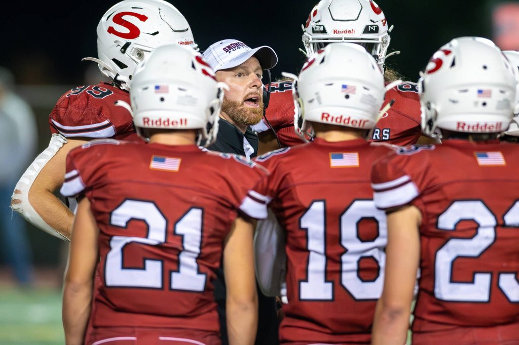 Snohomish head coach Joey Hammer talks to his players during a timeout in a game against Glacier Peak on Sept. 1, 2023, at Snohomish High School. (John Gardner / Pro Action Image)