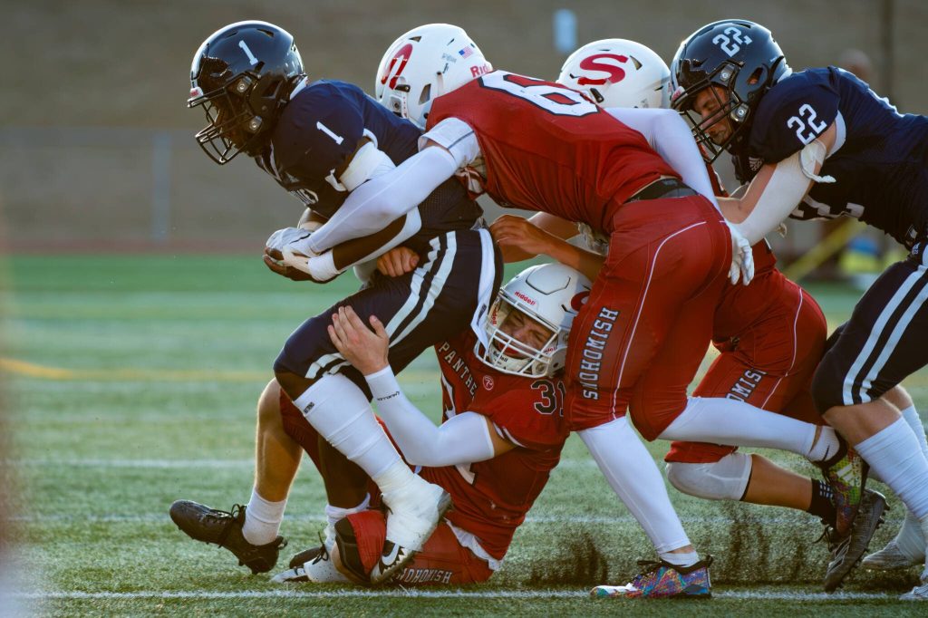 Snohomish players gang up to tackle Glacier Peaks Chrisvin Bonshe during a game on Sept. 1, 2023, at Snohomish High School. (John Gardner / Pro Action Image)