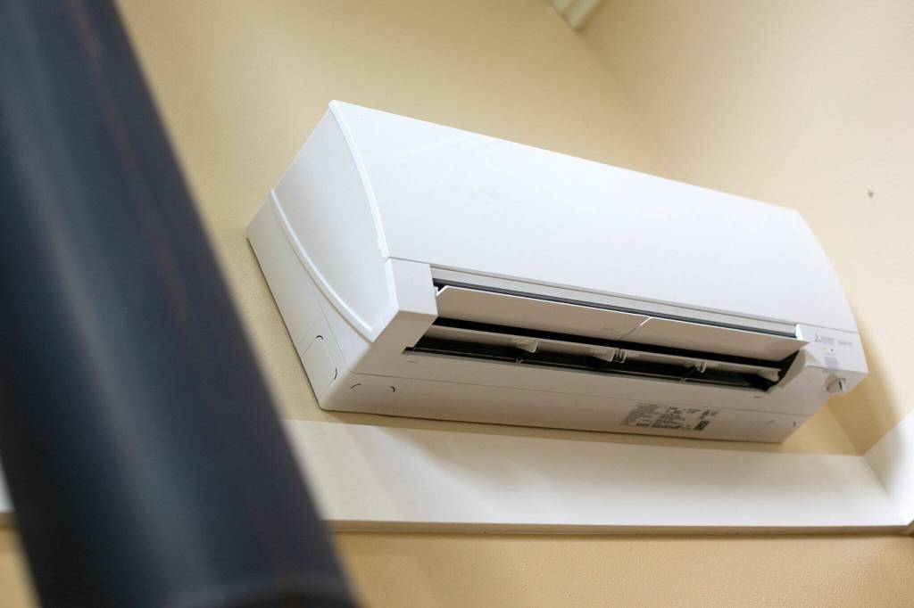 A Mitsubishi Electric heat pump is installed on the wall of Jim and Chris Hall home on Thursday, Sep. 7, 2023, near Langley, Washington. (Ryan Berry / The Herald)