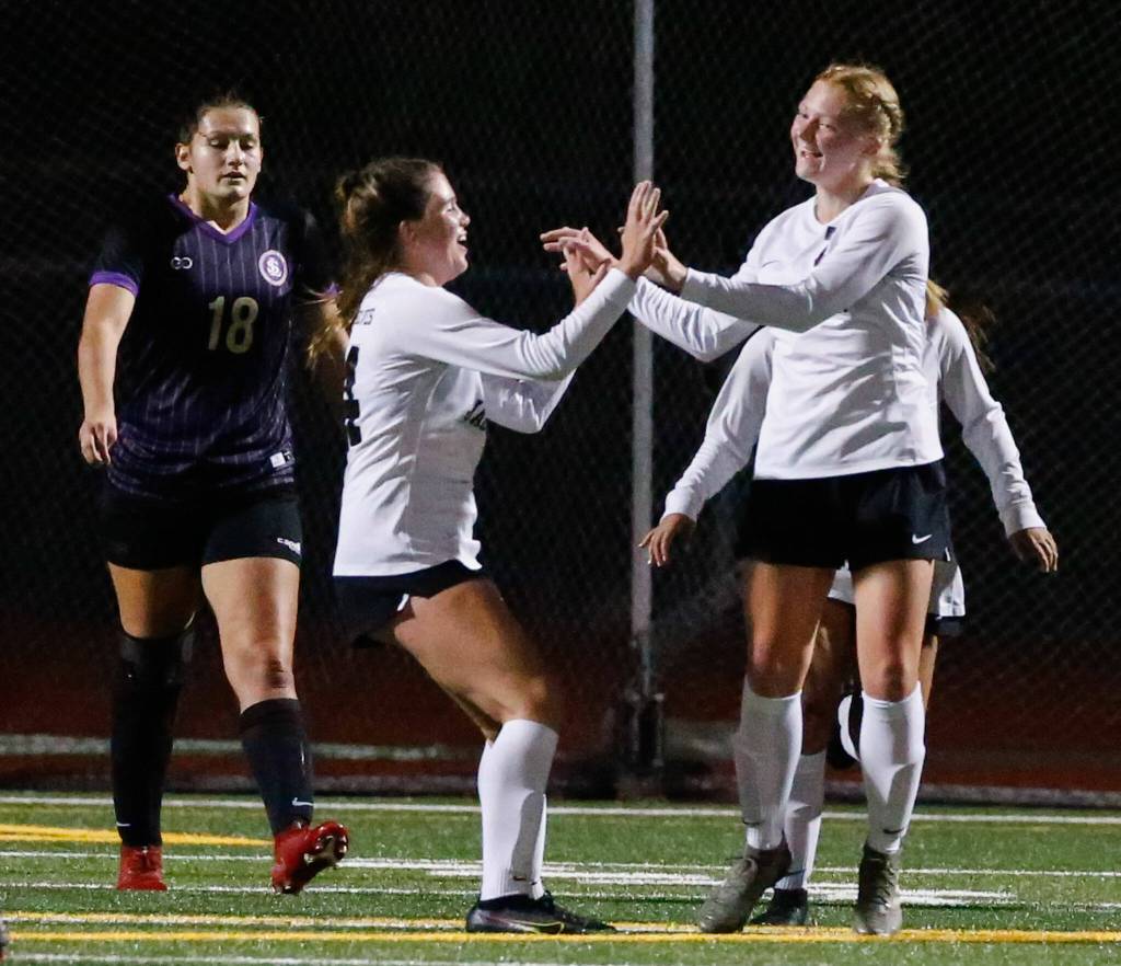 Jacksons Tia Schwetz (right) celebrates a goal against Lake Stevens on Sept. 28, 2021, at Lake Stevens High School. (Kevin Clark / The Herald)