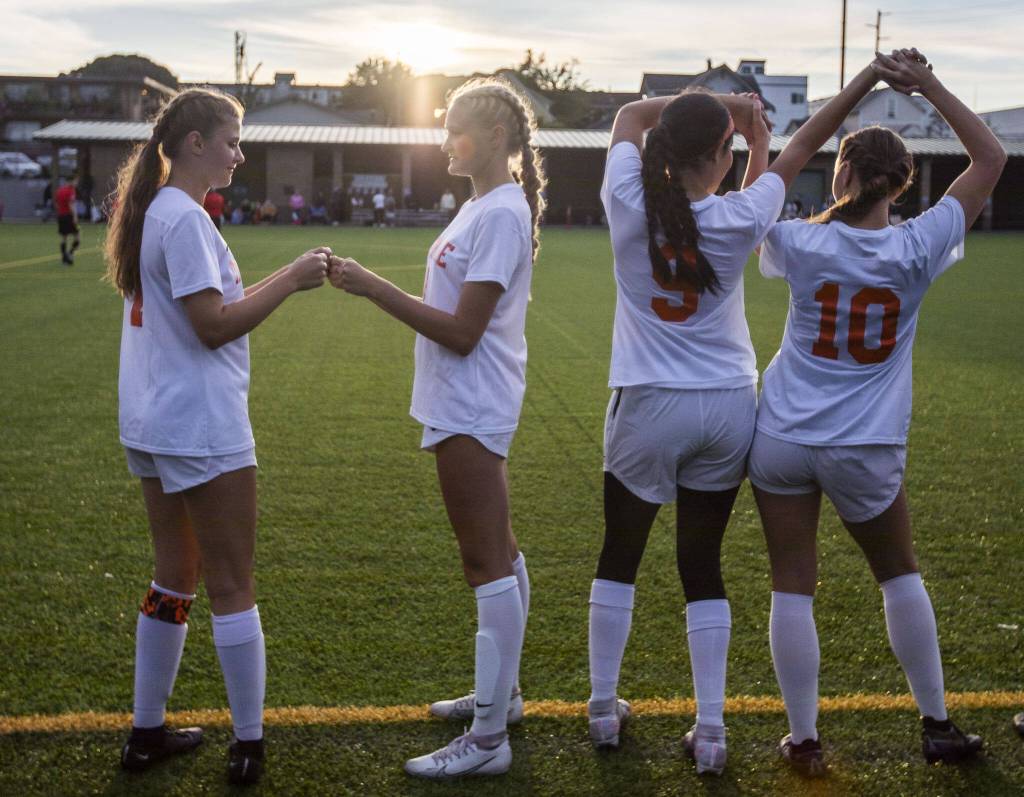 Monroe players work on their handshakes before being announced during the start of the game on Thursday, Sept. 7, 2023 in Everett, Washington. (Olivia Vanni / The Herald)
