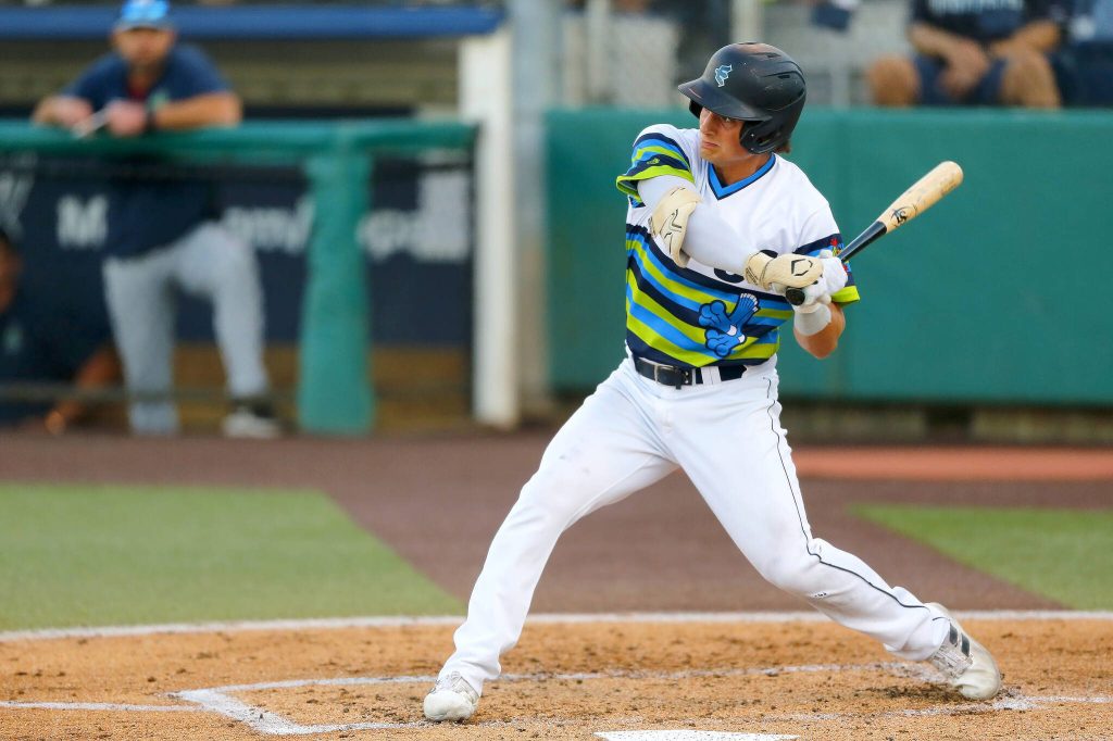 AquaSox shortstop Cole Young, one of Seattle’s top prospects, steps into a swing while batting during a game against Hillsboro on Thursday, August 17, 2023, at Funko Field in Everett, Washington. (Ryan Berry / The Herald)