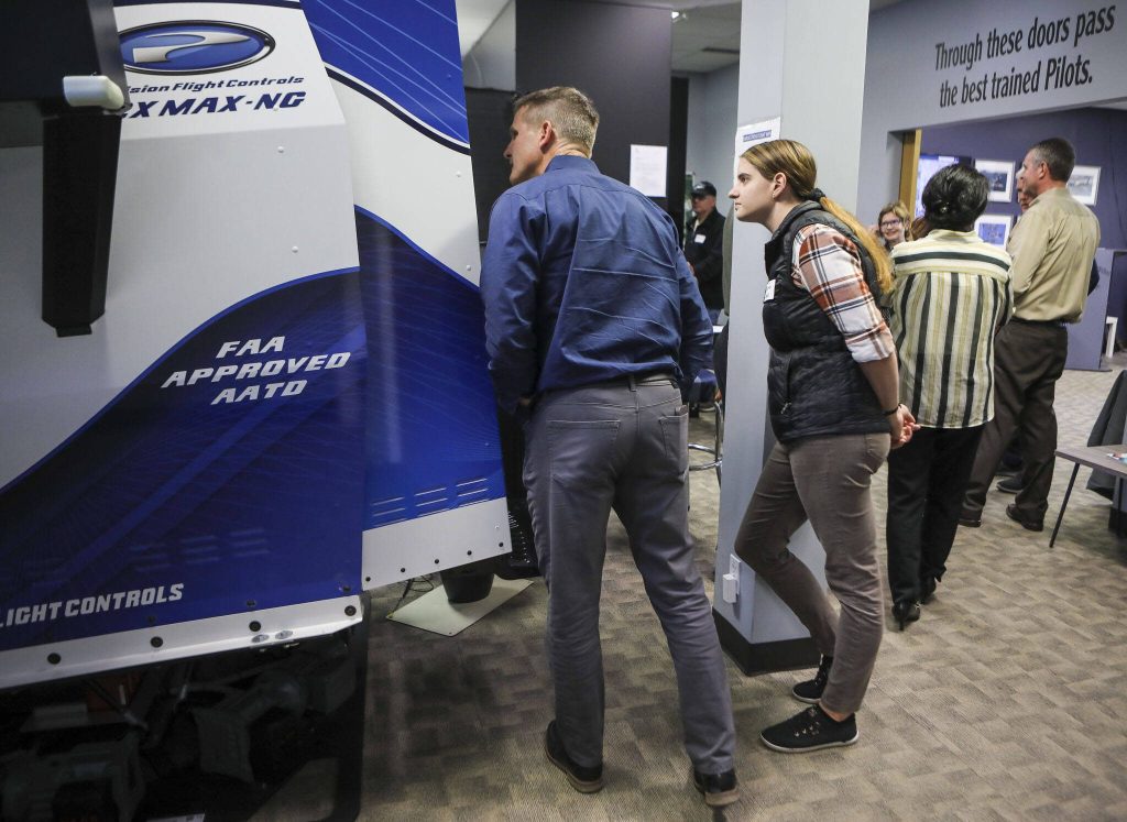 Attendees view different training opportunities during an opening event for the Boeing 737 simulator at Simulation Flight in Mukilteo, Washington on Wednesday, Sept. 20, 2023. (Annie Barker / The Herald)
