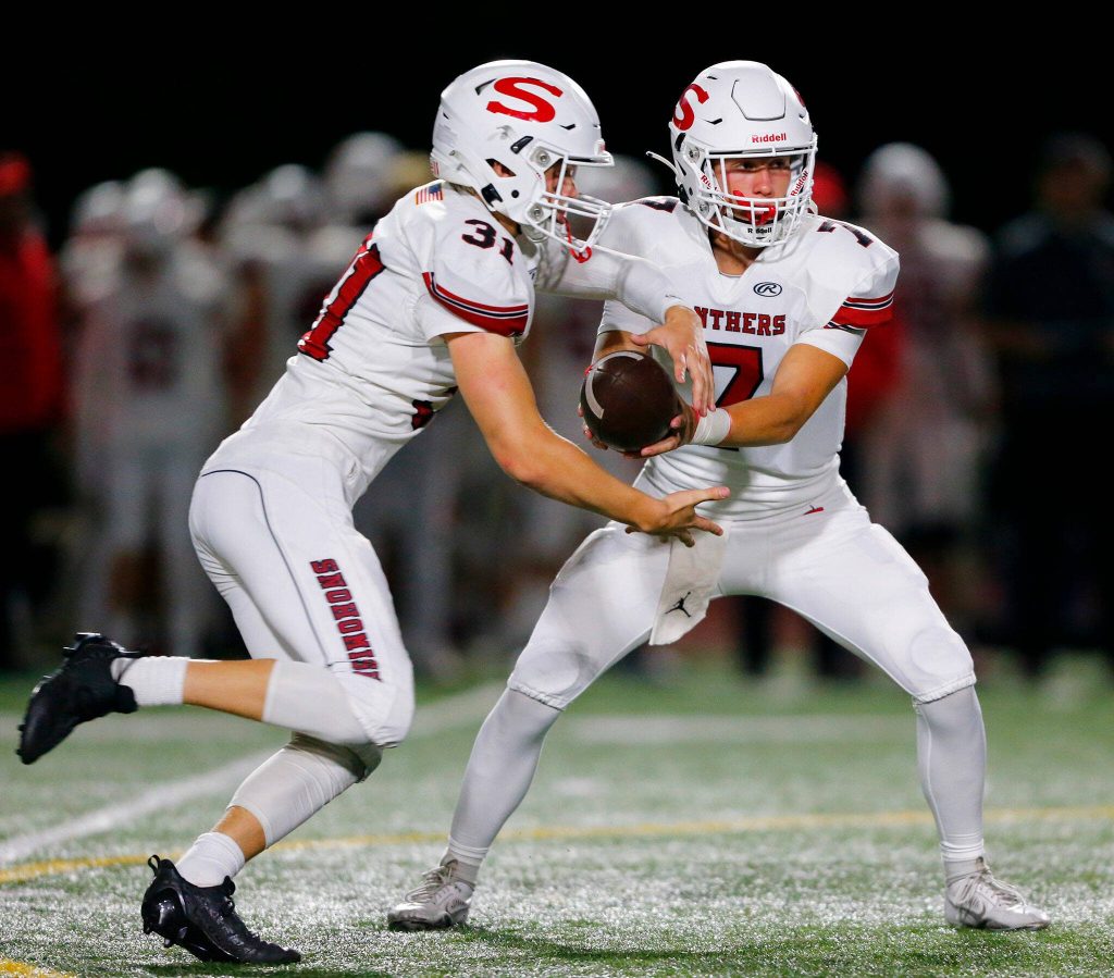 Snohomish running back Zayah Nelson takes the handoff from David Hammer during a game against Mountlake Terrace on Friday, Sept. 8, 2023, at Edmonds Stadium in Edmonds, Washington. (Ryan Berry / The Herald)