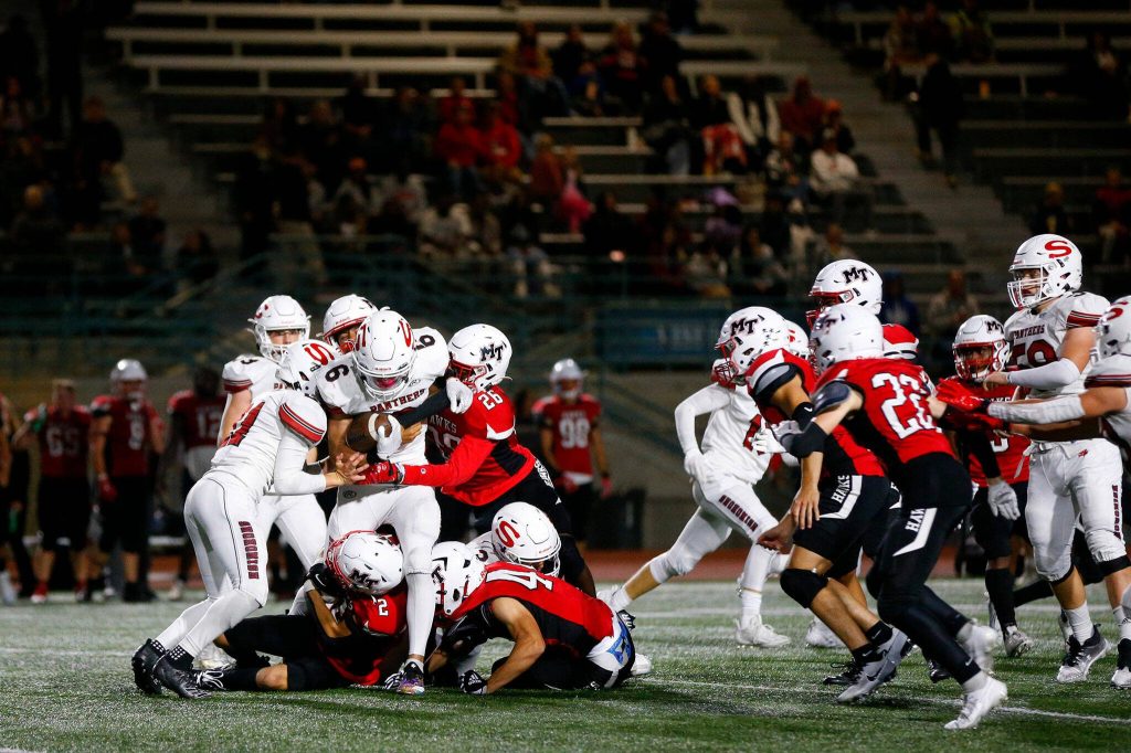Snohomishs Parker Jackson gets rounded up by a gang of defenders against Mountlake Terrace on Friday, Sept. 8, 2023, at Edmonds Stadium in Edmonds, Washington. (Ryan Berry / The Herald)